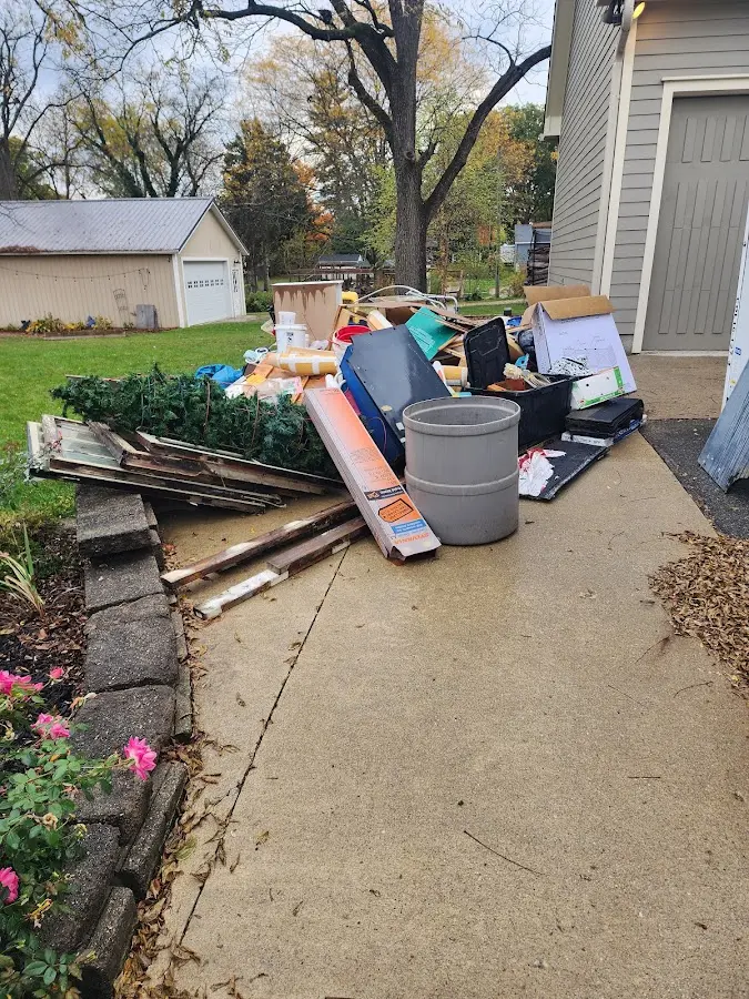 Dumpster being loaded with debris for Residential Dumpster Rental in Swanton